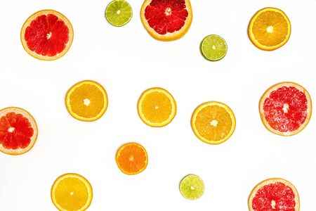 Creative sample of lime, orange and grapefruit. flat lay. Food concept. Lime, orange and grapefruit on a white background. Flat layout.の写真素材