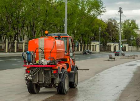 Russia, Moscow - May 7, 2020: Machines for irrigation of sidewalks. Housing and utilities use water to clean expensive dustのeditorial素材