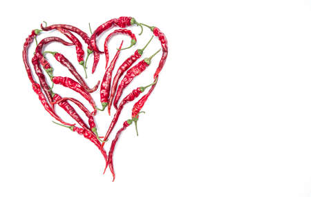 Heart of small chili peppers isolated on a white background. Copyspace for textの写真素材
