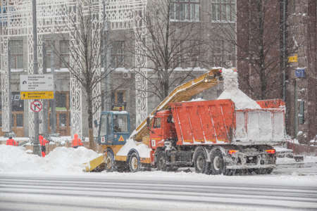 Moscow, Russia, February 13, 2021: A snowplow cleans the street after a severe blizzard.