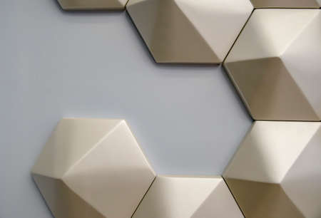 Gray wall with abstract geometric pattern in golden color. Background picture.