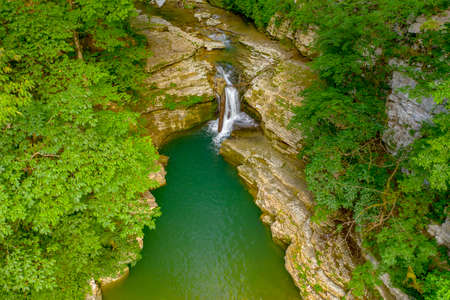 Waterfall on the Wet Canyon of the Psakho River. Mountain river with blue water. Sochi, Russia