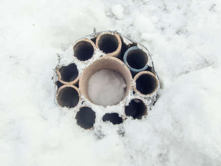 Burnt fireworks in the snow. Garbage after the holiday. New Year. Pollution of nature with rubbish.の写真素材