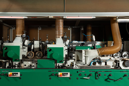 Industrial woodworking machine. Rollers, cutting elements and exhaust pipes for waste removal are...