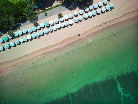 Unforgettable summer moments on the serene emerald beach of Sanur, Bali, captured from aboveの写真素材
