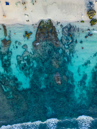 Breathtaking summer drone view of Balis turquoise waters and sandy beachesの写真素材