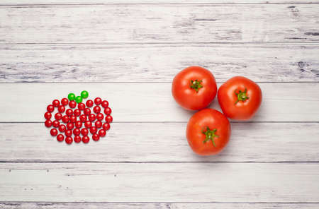 Tomatoes versus candyの写真素材