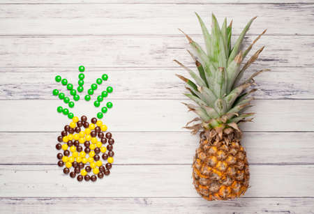Pineapple versus candyの写真素材