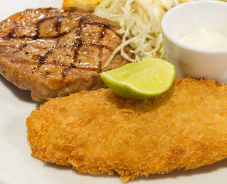 Breaded fish steak with steak or porkの写真素材