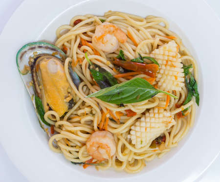 Spaghetti spicy with seafood on a white plateの写真素材