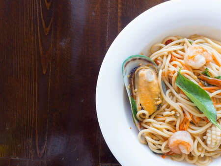 Spaghetti spicy with seafood on a white plateの写真素材