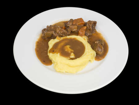 Beef stew with mashed potatoes isolated on the black background with clipping pathの写真素材