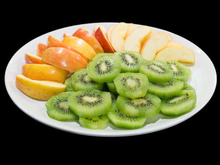 Green kiwi slices and red apple slices isolated on the black background with clipping pathの写真素材