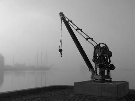 Retro crane a foggy day in the harbour.の写真素材