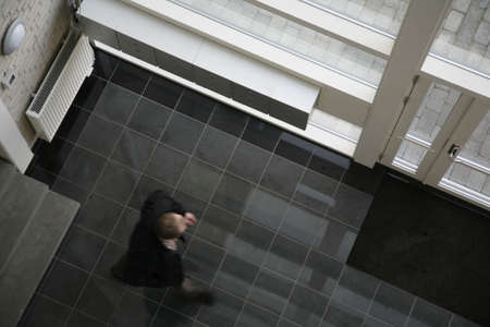 Hall seen from above in a new condominium. A busy man on his way out...の写真素材