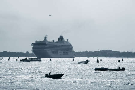 Heavy traffic outside the city of Venice - Italy. Cruise liner, chopper, ferry, taxi and transport wessels around each other in the lagoon.の写真素材
