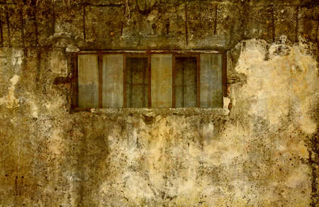 Detail from a grunge wall with window.の写真素材