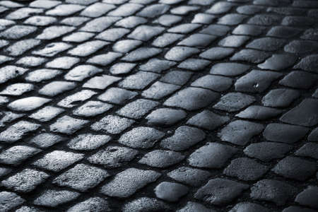 Wet cobblestone at nighttime - Denmark. Very shallow DOF.の写真素材