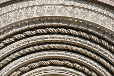 Detail of the facade of Orvieto Cathedral. (1290 - 1600 a. c.) Richly decorated with lots of stone mosaics and reliefs as well as pattern and artistic coils all over the facade.の写真素材