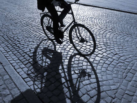  A warm spring afternoon a young man is biking through the old streets of Copenhagen, Denmark.                      の写真素材