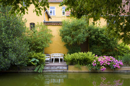 Beautiful, tiny backyard garden down to the river - Frederiksvaerk, Denmarkの写真素材
