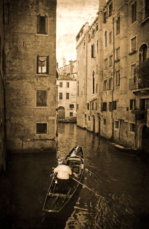 Urban canal Venice, Italy with gondola in retro style.の写真素材