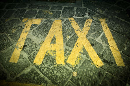 Taxi -  text painted in the street.の写真素材