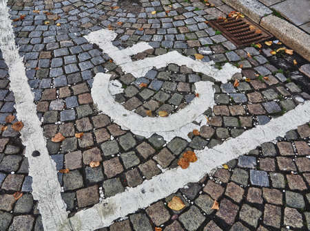 Grunge painted parking symbol for disabled in the old part of the city.の写真素材