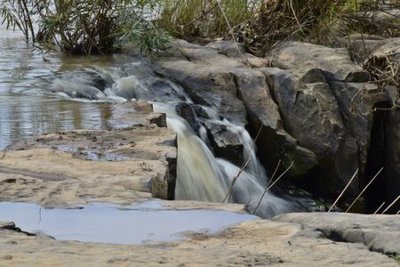 Waterfall flowing along the rock.の写真素材