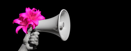 Hand holding a megaphone or loudspeaker with pink lily flowerの素材