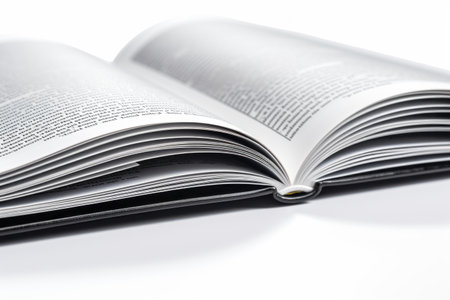 Open book isolated on white background, close-up macro photo.の素材
