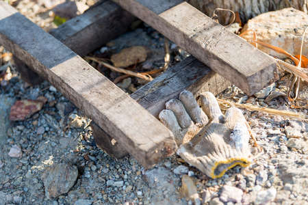 The glove was left beside a pile of woodの写真素材