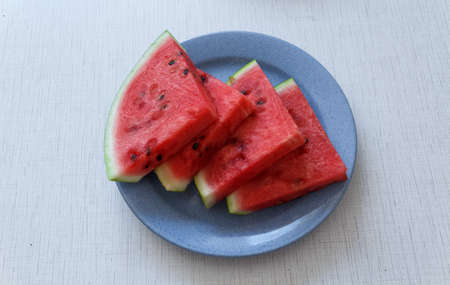 Juicy big red watermelon lying on a woodenの写真素材