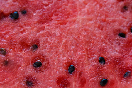Juicy big red watermelon lying on a woodenの写真素材