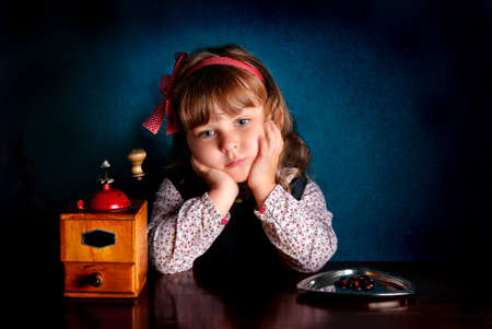 Little caucasian girl with coffee mill. Retro stileの写真素材