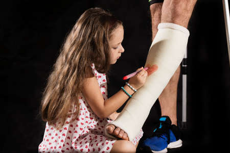 A little girl drawning on plaster castの写真素材