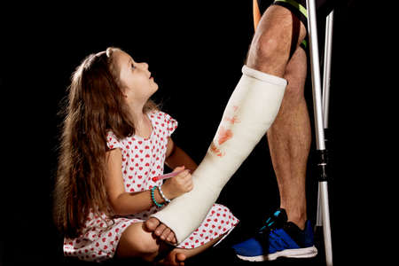 A little girl drawning on plaster castの写真素材