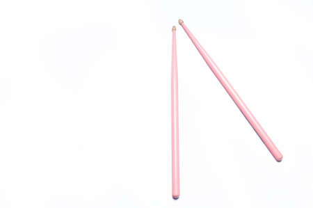 Pink drumsticks on white background