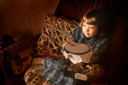 Little girl with needlework.の写真素材