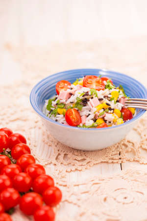 Rice salad with pork steak, tomatoes, corn seeds and tomatoesの写真素材