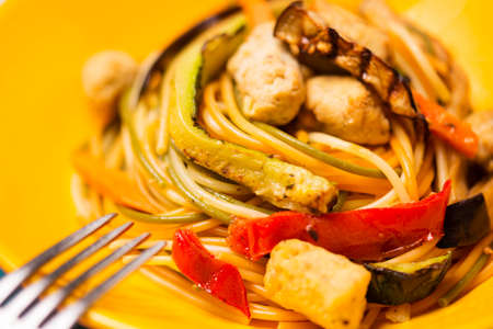 Multicolored vegetarian pasta with soya croquette and grilled vegetablesの写真素材