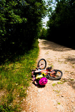 Little girl falling off her bicycleの写真素材