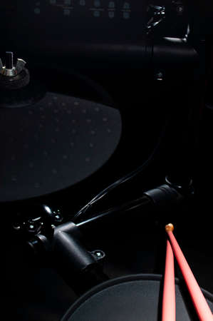 Old electronic Drum Kit and pink drumsticks
