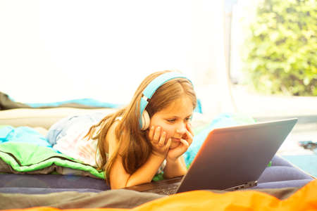 Little caucasian girl with notebook in the tent
