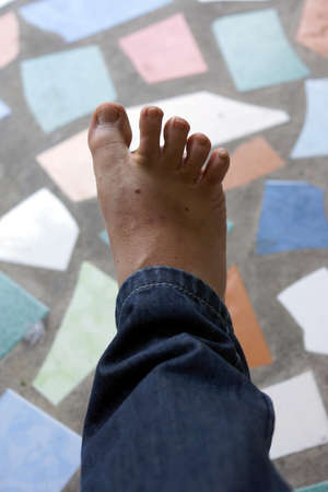 Foot on colorful background