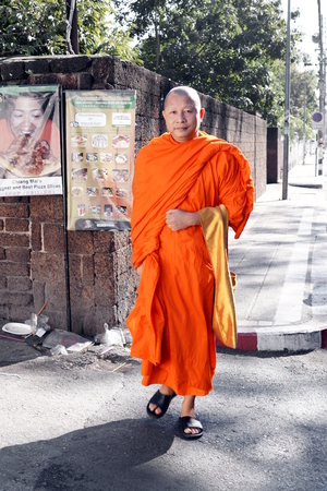 CHIANG MAI, THAILAND - February 03, 2014: A Buddhist monk goes around for the streets looking for offers in Chiang mai, Thailand.のeditorial素材