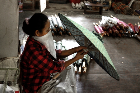 CHIANG MAI, THAILAND - February 05, 2014: Artisan working manually in an traditional ancient factory in Chiang mai, Thailand.のeditorial素材