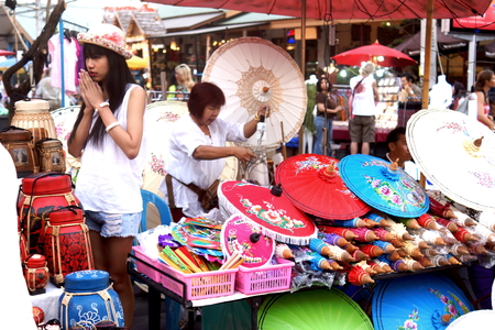 CHIANG MAI, THAILAND - February 16, 2014: Tourists and passers-by walking among the stalls and street artists of the Sunday Market in Chiangmai, Thailand.のeditorial素材