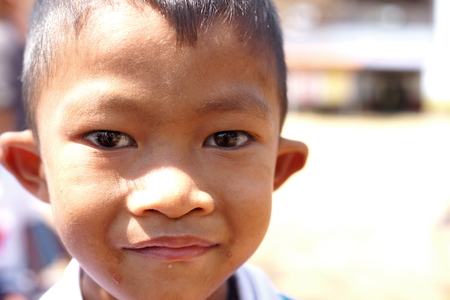 BAN BO NAM CHING, SA KAEW, THAILAND - February 10, 2014: Children eating, drinking and playing in the coutyard of a school in Ban bo nam ching, Sa kaew, Thailand.のeditorial素材