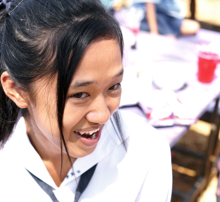 BAN BO NAM CHING, SA KAEW, THAILAND - February 10, 2014: Children eating, drinking and playing in the coutyard of a school in Ban bo nam ching, Sa kaew, Thailand.のeditorial素材